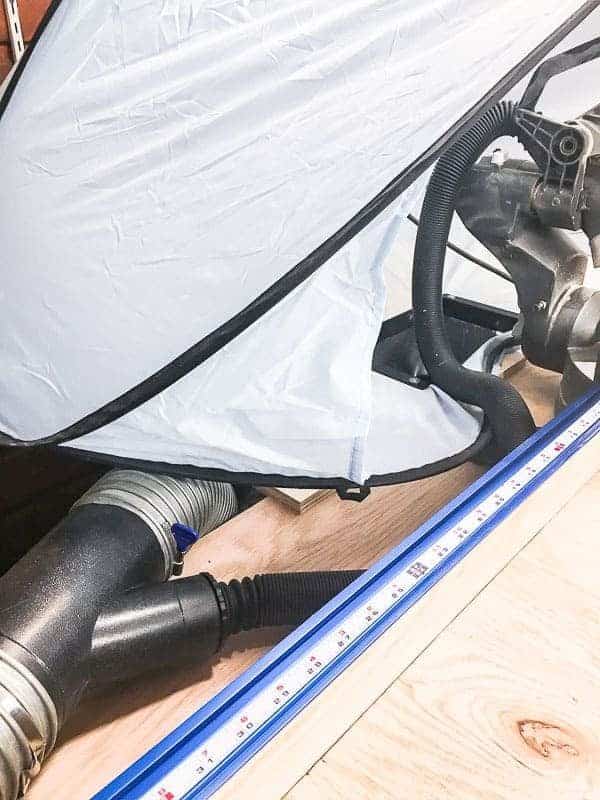 miter saw dust hood with Y shaped dust collection fitting attached to dust funnel and dust port on miter saw