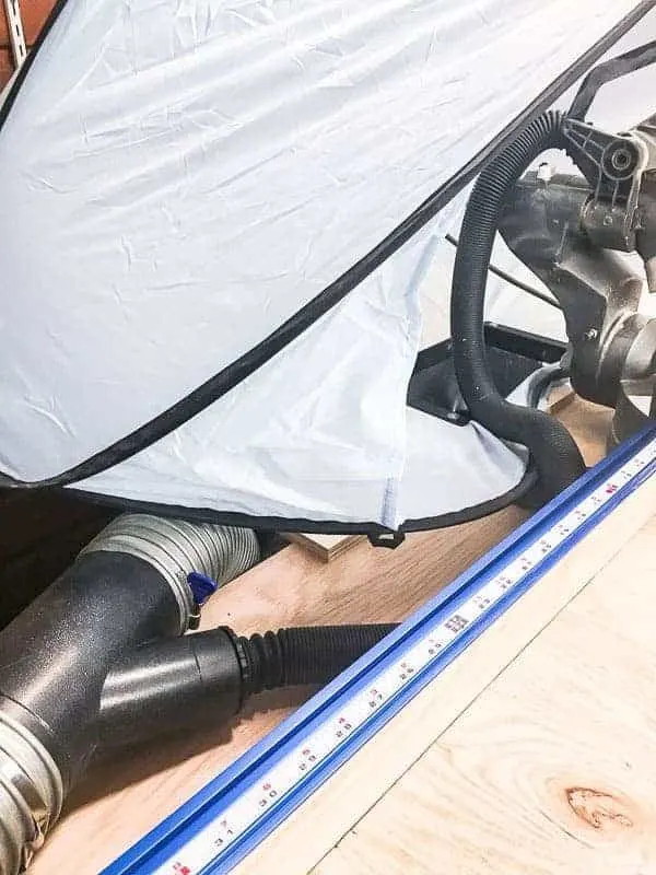miter saw dust hood with Y shaped dust collection fitting attached to dust funnel and dust port on miter saw