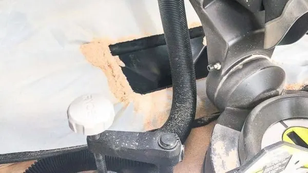 sawdust collecting around the dust funnel of the miter saw dust hood