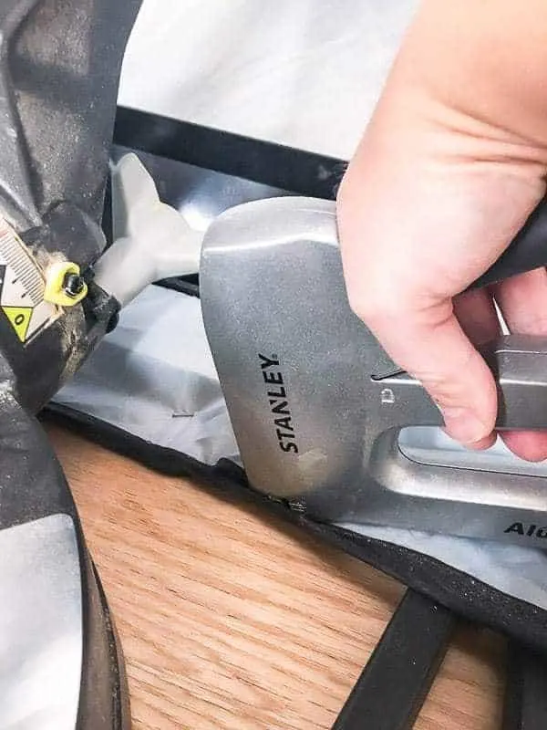attaching the miter saw dust hood fabric to the miter saw stand