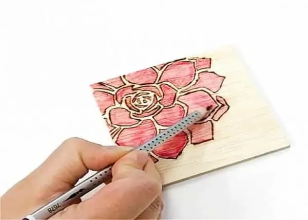 applying watercolor pencil to wood burned coaster