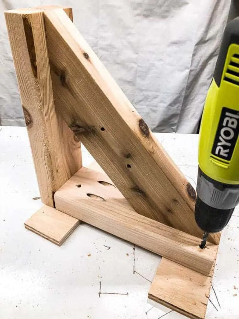 drilling holes for screws in garden tool storage rack