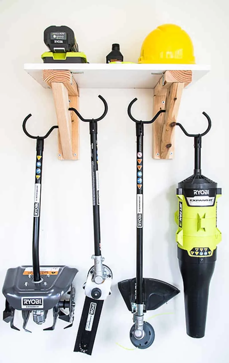 garden tools hanging from garden tool storage rack