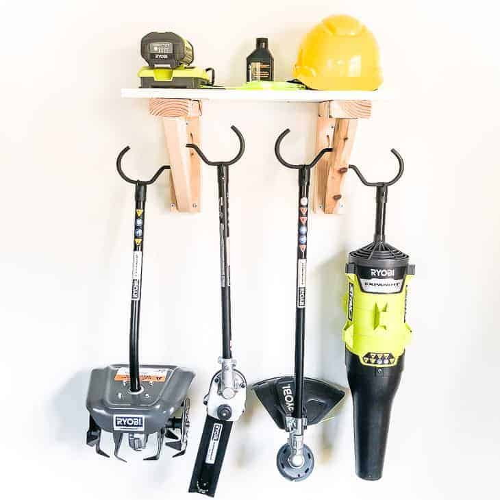 Get your tools off the floor and on the wall with this simple garden tool storage rack!
