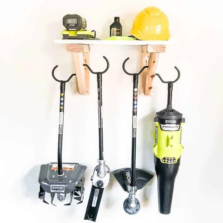 Get your tools off the floor and on the wall with this simple garden tool storage rack!
