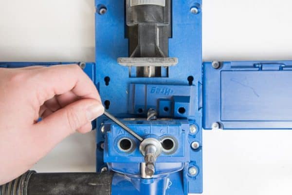 adjusting the height of the stop collar on the Kreg Jig drill bit