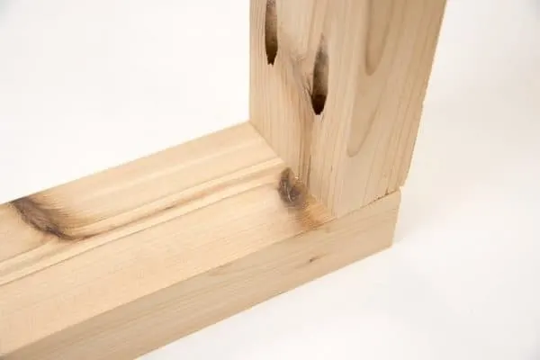 Two 2x4 boards joined incorrectly at a 90 degree angle with pocket holes