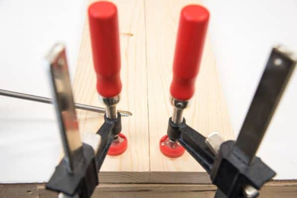 Two boards with pocket holes clamped to a workbench