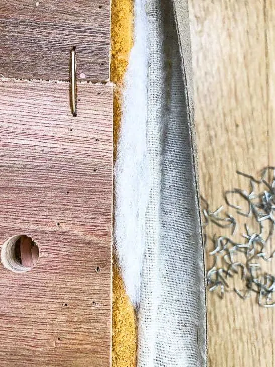 ottoman cover being removed with pile of staples