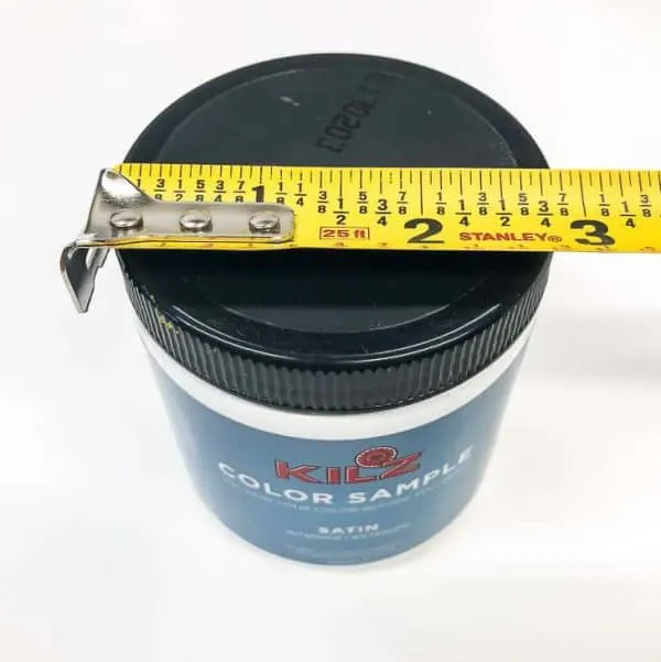 measuring tape with small jar of paint