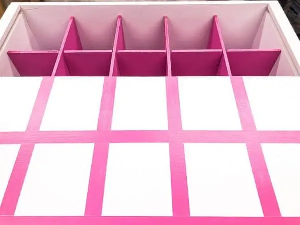 white box with pink box dividers, and white lid with pink grid painted on top