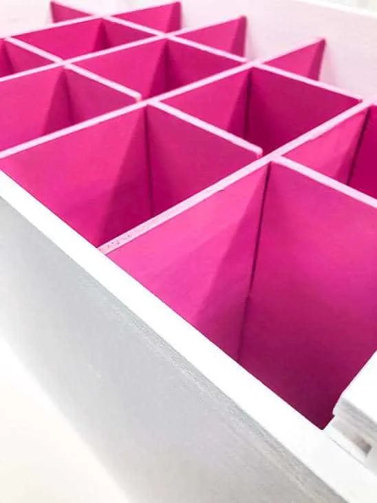 white box with bright pink box dividers