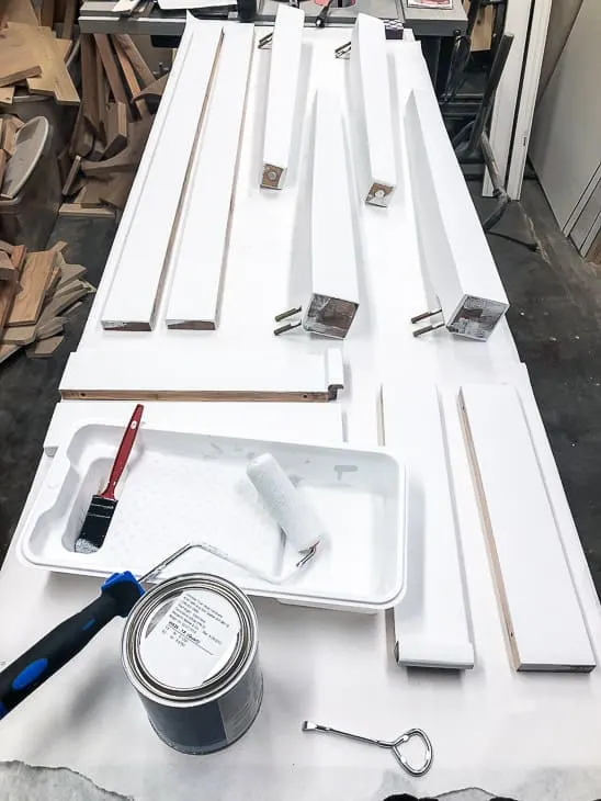 table pieces on a workbench being painted white