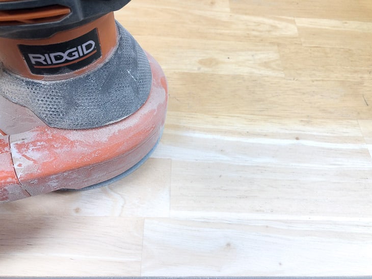 orbital sander removing old stain from tabletop