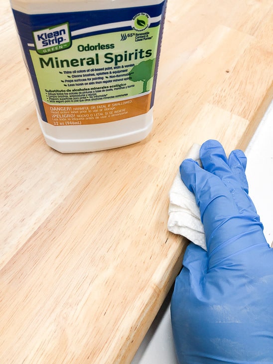 mineral spirits being applied to table top