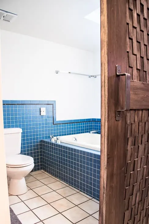 bathroom with almond fixtures behind barn door