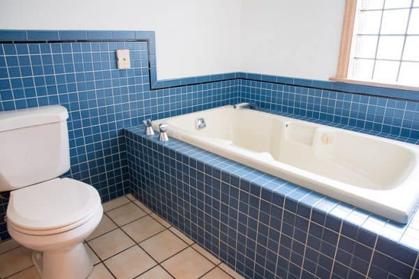 almond tub and almond toilet with cobalt blue tile in bathroom