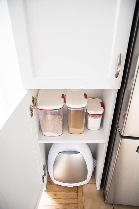 pantry with baking supplies and automatic vacuum