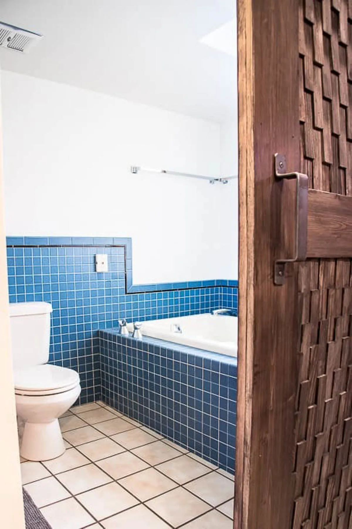 bathroom with almond fixtures behind barn door