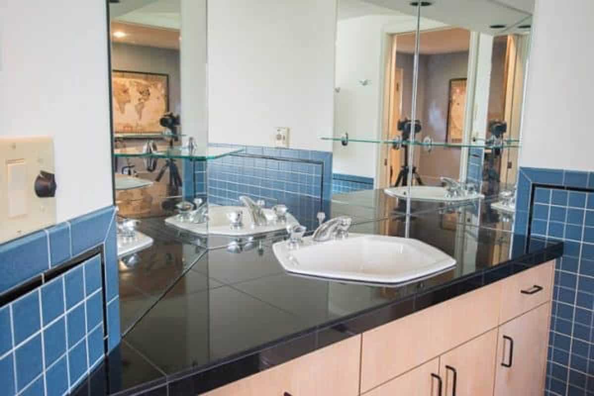 Multiple mirrors on the walls create a fun house effect, and the hexagon sink has GOT to go!