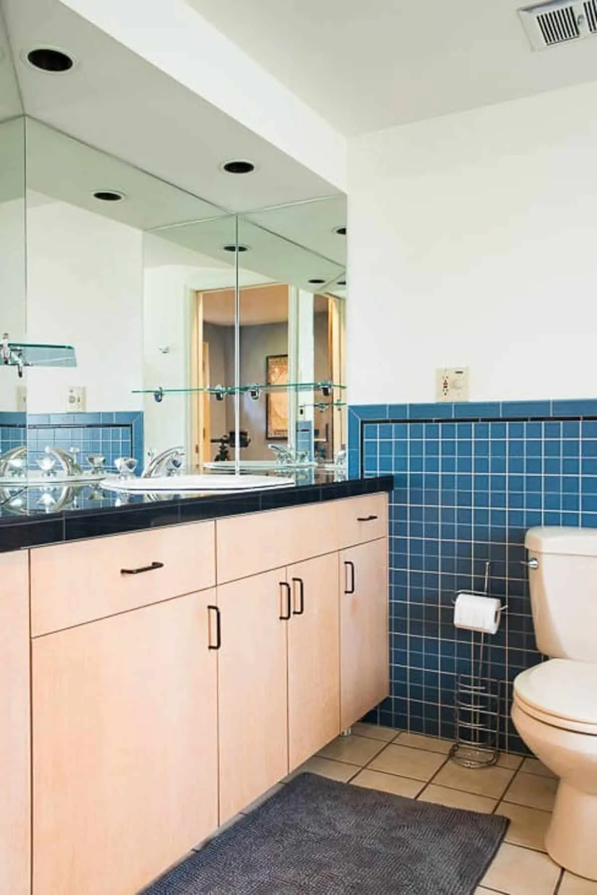 bathroom with almond fixtures, dated vanity and multiple mirrors