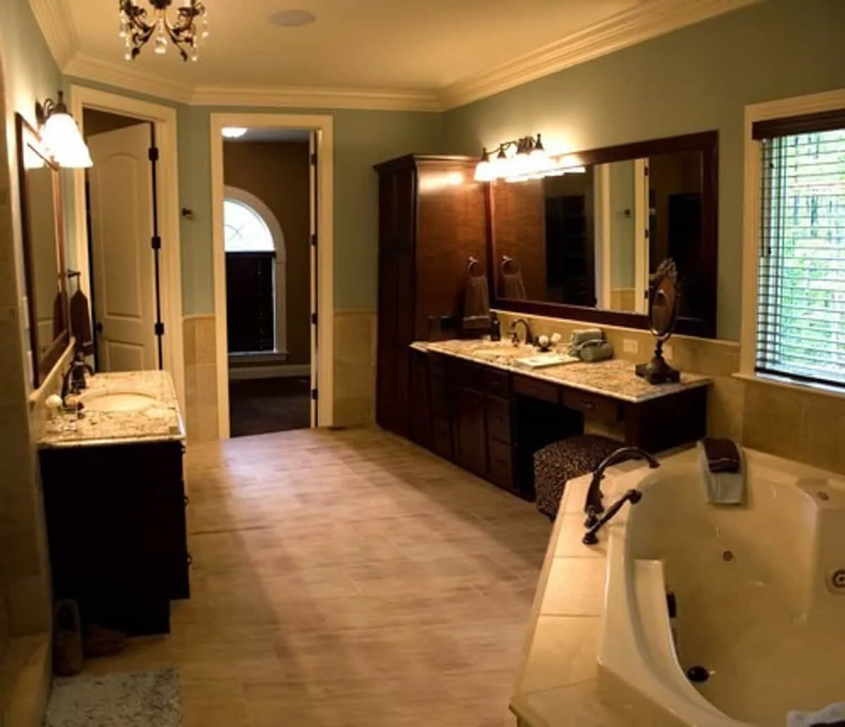 large bathroom with almond bath fixtures and dark wood cabinetry