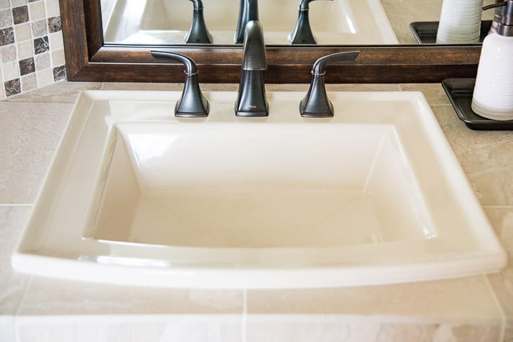almond sink in DIY bathroom renovation with caulk around sink