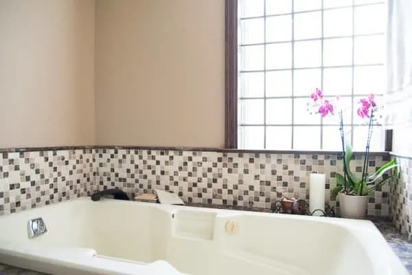 bathtub with wall tile completed during DIY bathroom renovation