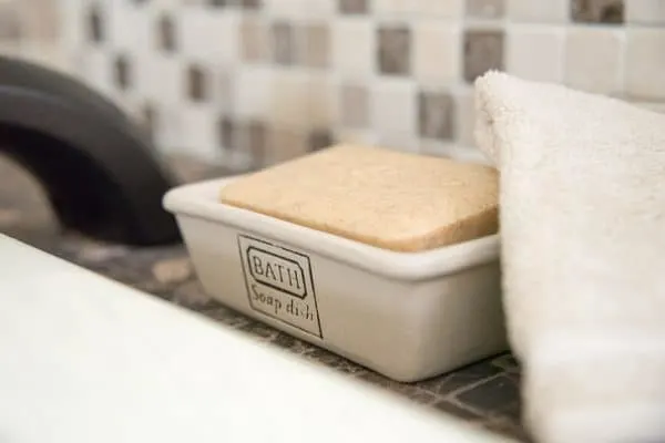 fancy bath soap in soap dish with washcloth