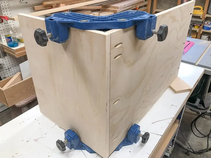 back and side of the shoe storage bench held together with corner clamps