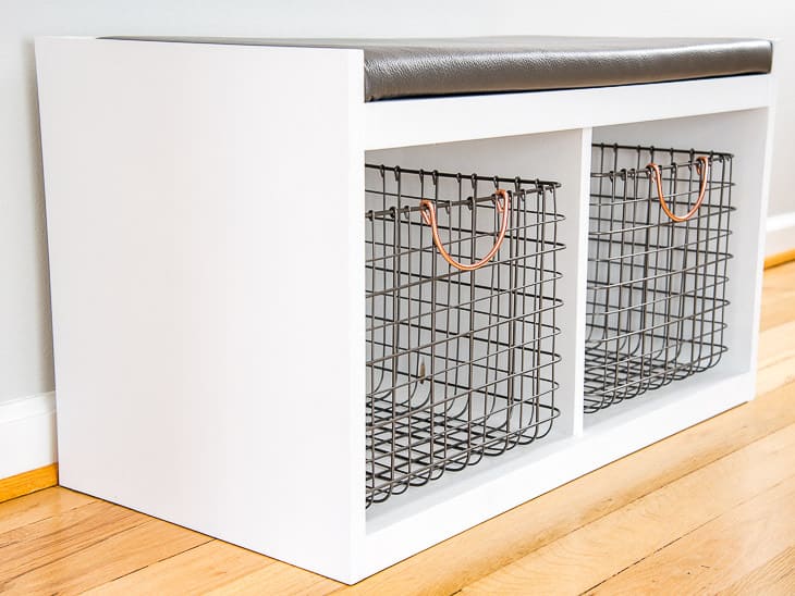 DIY entryway bench with farmhouse style metal baskets and leather cushion on top