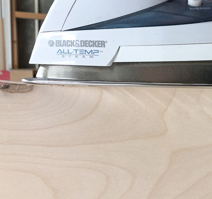 applying iron on edge banding to the exposed plywood edges of the shoe storage bench