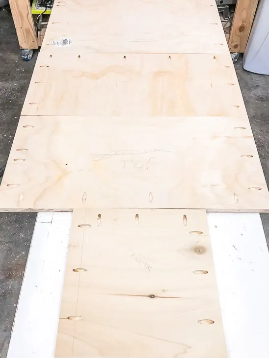 pocket holes drilled into plywood pieces for entryway bench with shoe storage