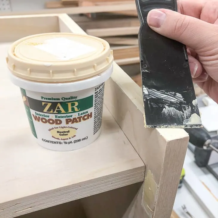 applying wood filler to exposed plywood edges