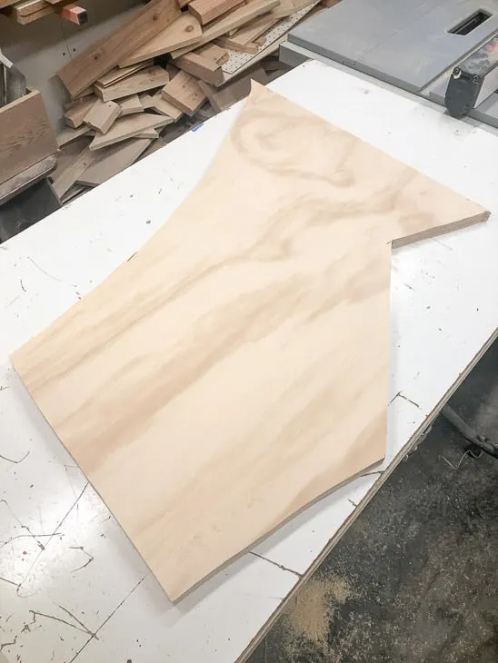 oddly shaped plywood scrap to be cut into between the studs shelving