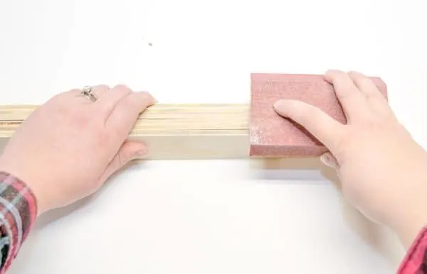 sanding edges of plywood slats for DIY martial arts belt display