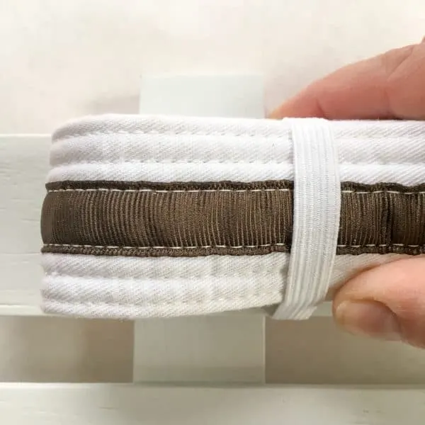 wrapping elastic around martial arts belt for display