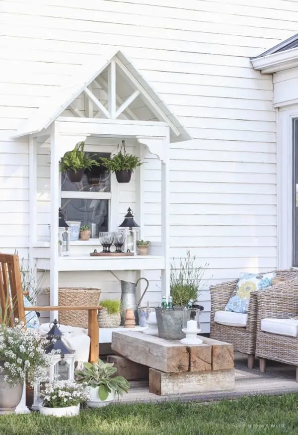 white DIY potting bench with decorative roof