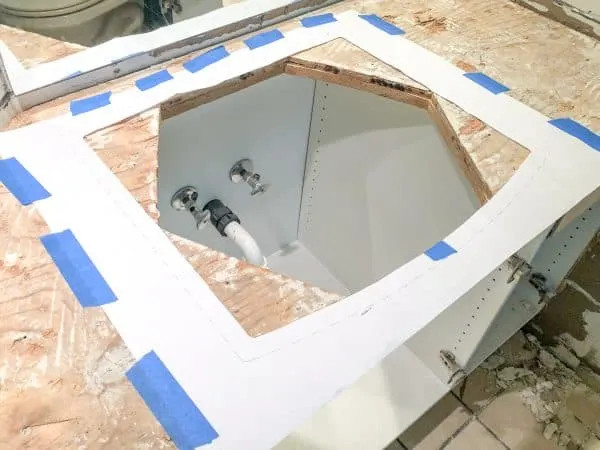 hexagon shaped sink hole with rectangular template for new sink over it