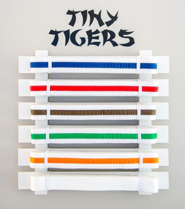 DIY martial arts belt display with "Tiny Tigers" vinyl decal