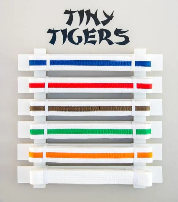 DIY martial arts belt display with "Tiny Tigers" vinyl decal