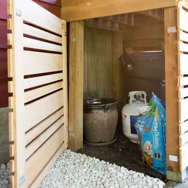 under deck stairs storage area with removable fence panel at end