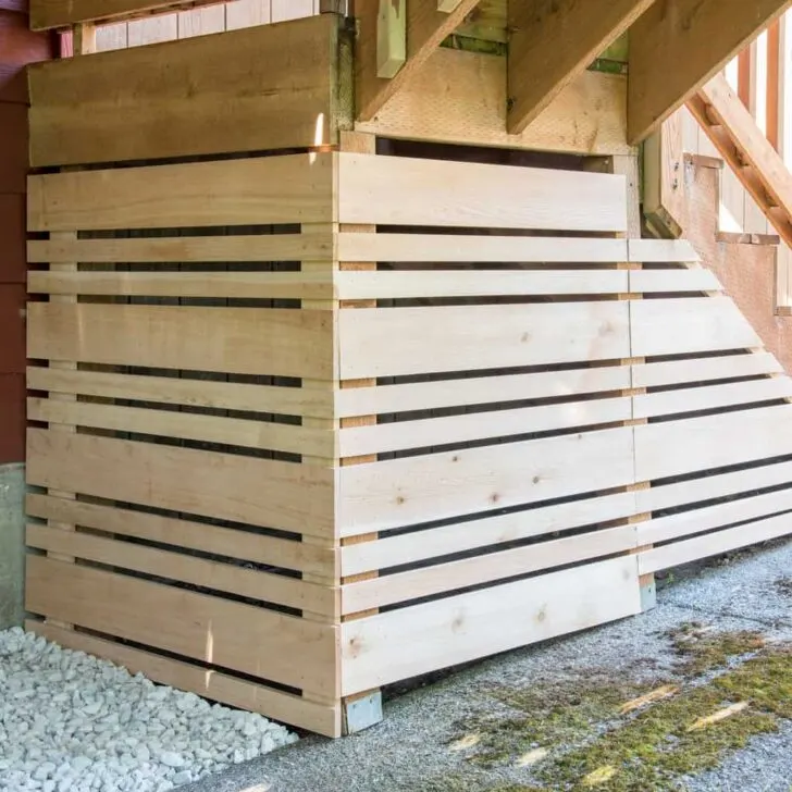 fenced in area under deck stairs for storage with removable fence panel for easy access