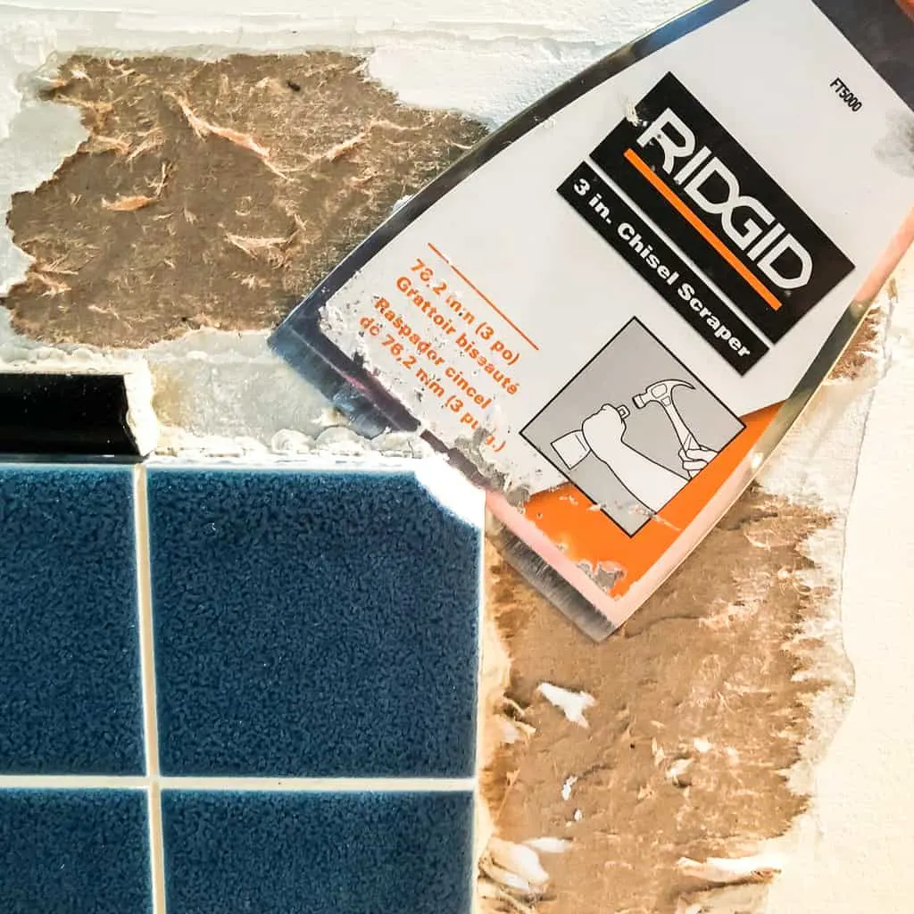 chisel removing tile from wall