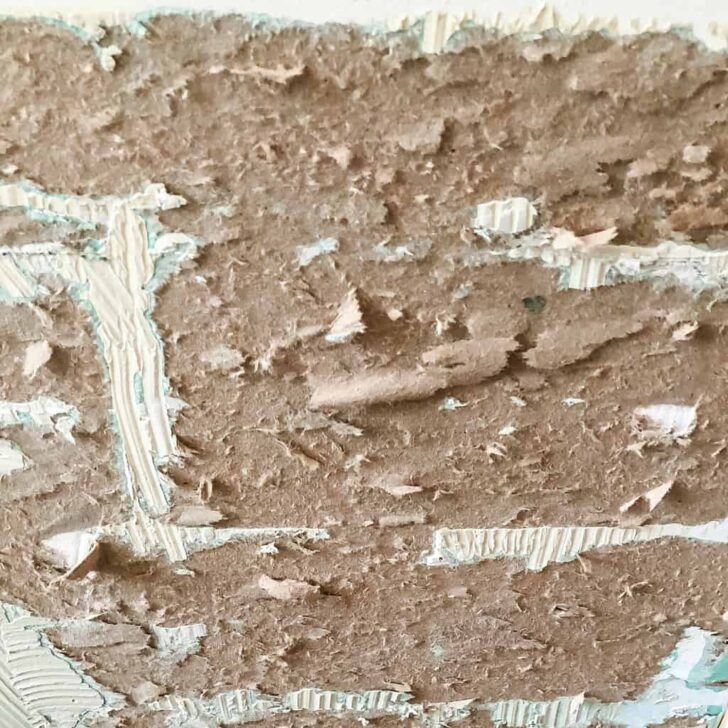 torn drywall paper after removing wall tile