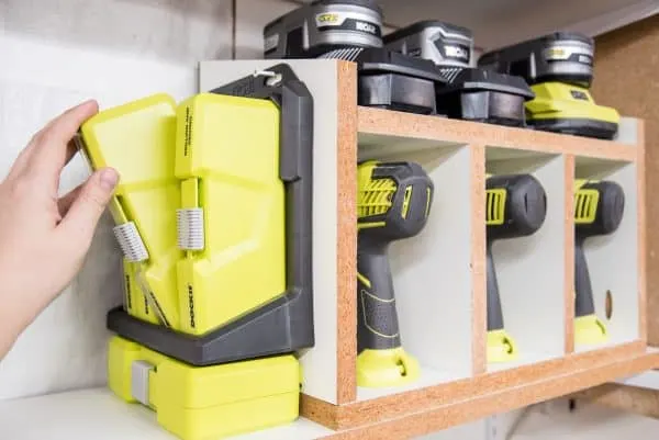 cordless drill storage rack with attached Ryobi Dock-it shelf for drill bits