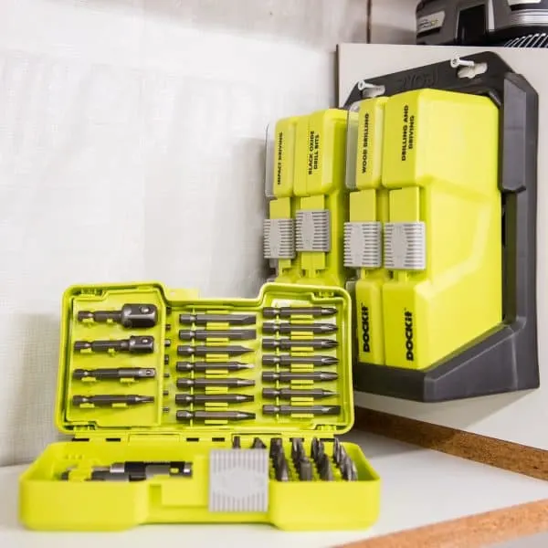 Ryobi dock-it shelf mounted on cordless drill storage rack with one case open