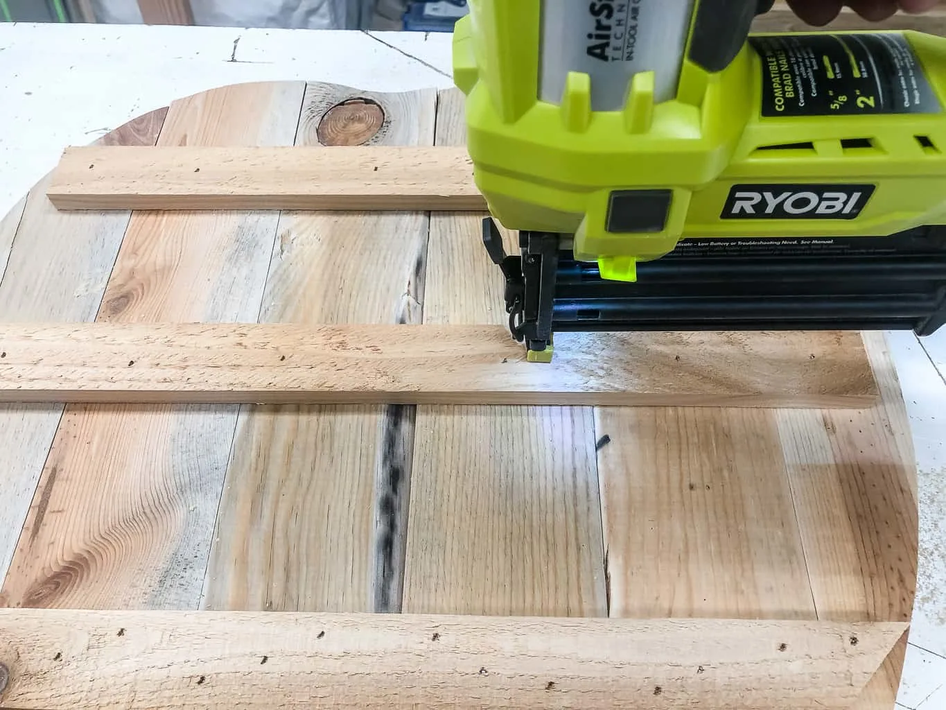 attaching pallet pumpkin pieces together with Ryobi brad nailer