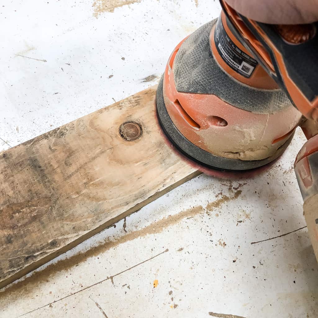 sanding down pallet wood for the pallet pumpkin trio