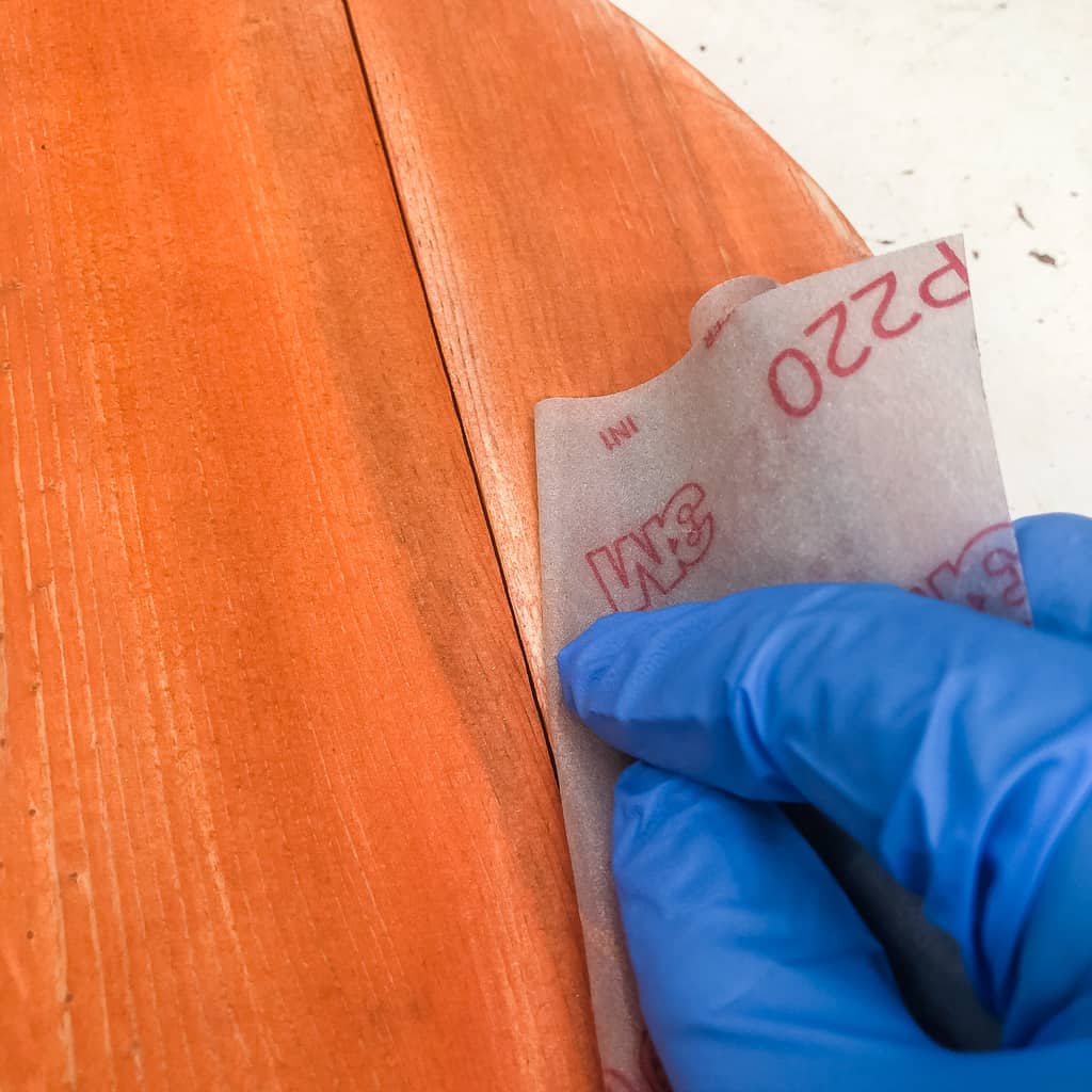 sandpaper sanding edges of pallet pumpkin